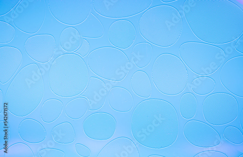 Blue background of decorative plaster with abstract spots. Unusual texture of this wall with beautiful patterns  creative surface background. Finishing coating for building cladding.
