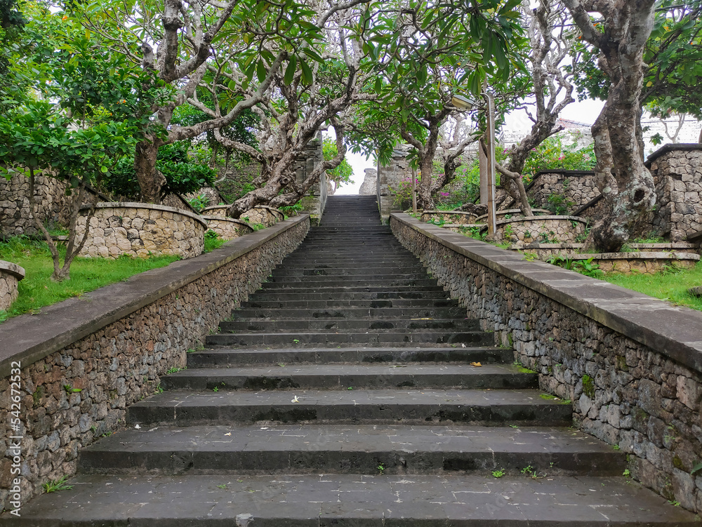 Stairs inside of balinese temple Pura Uluwatu, Bali, Indonesia. Stone staircase background.