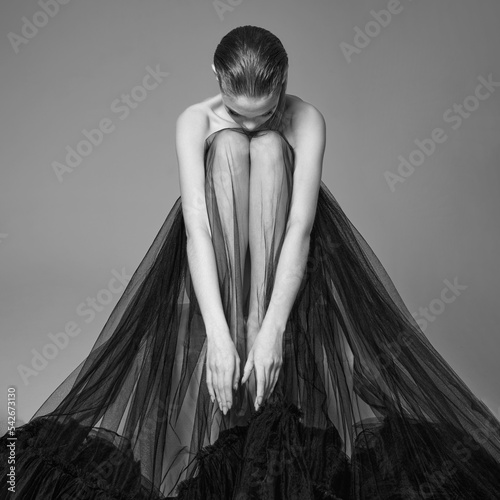 Beautiful woman pose in studio. Art portrait of a model in a bla