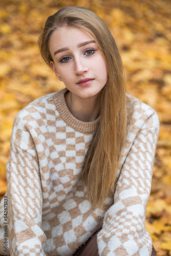 Young beautiful blonde woman posing in autumn park Young beautiful blonde woman posing in autumn park