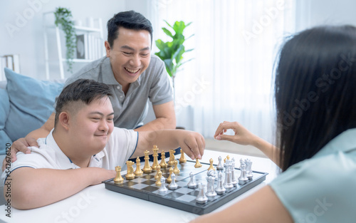 Asian families happily spend their free time together at home.