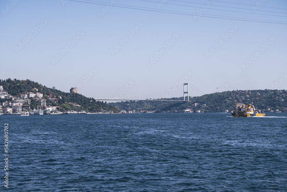 Fatih Sultan Mehmet Bridge from Arnavutkoy seaside, beautiful Istanbul view with blue sky and sea, cityscape idea, Marmara sea with houses in seaside