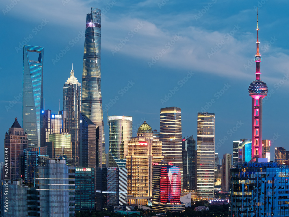 modern skyscrapers, Shanghai tower, jin mao tower, oriental pearl TV tower and shanghai world financial center, landmarks in lujiazui with blue sky background in dusk