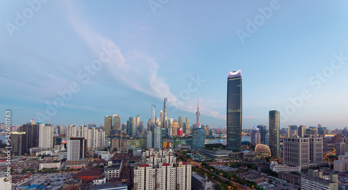 modern skyscrapers, Shanghai tower, jin mao tower, oriental pearl TV tower and shanghai world financial center, landmarks in lujiazui with blue sky background in dusk. photo