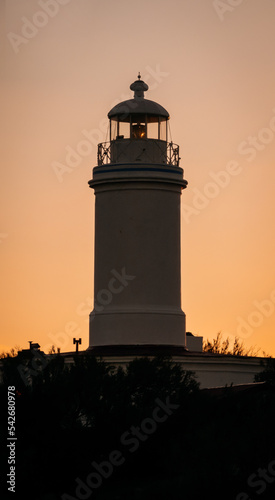 Small colonial lighthouse with amazing sunset. Close up caption