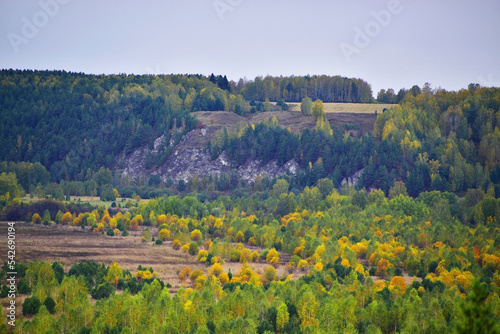 Autumn panorama of Mount Podkamennaya near the river Sylva