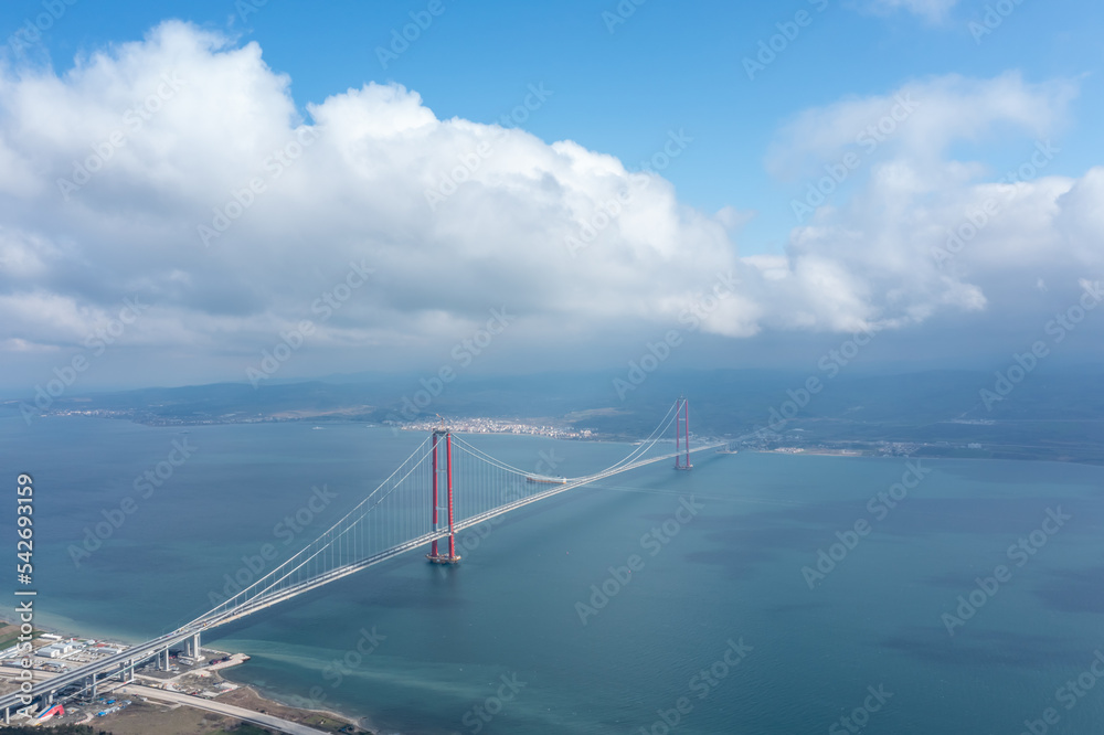 Fototapeta premium Aerial view of Hellespont and new made 1915 canakkale bridge and high way with white clouds and ships on the sea