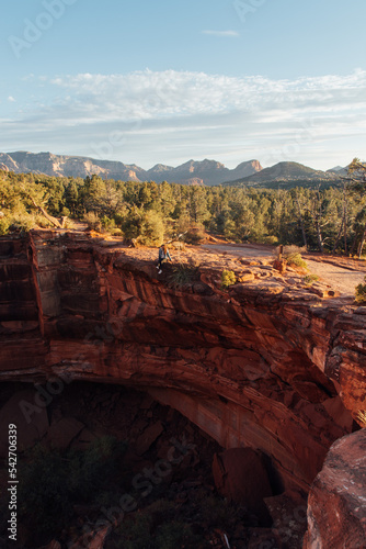 Girl on the edge of cliff sitting in Sedona
