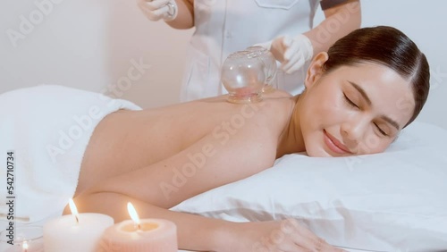.Beautiful Woman Received cupping treatment on back by  therapist, chinese medicine treatment, health and healing concept.