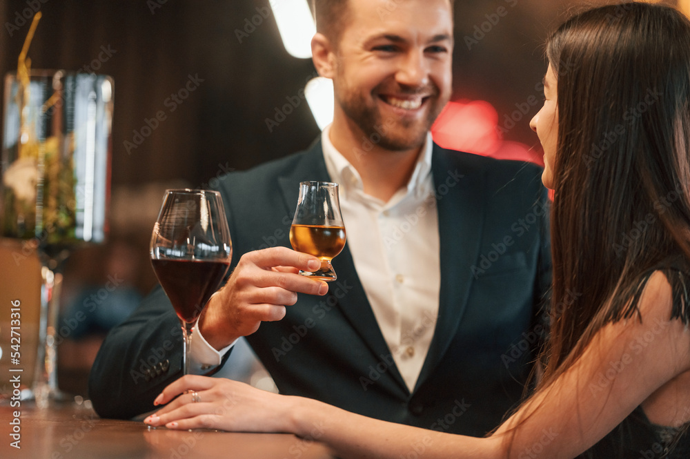 Sitting and drinking. Man and woman is together in the bar Sitting and drinking. Man and woman is together in the bar