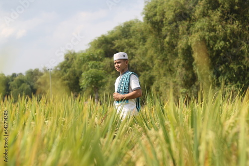 young asian muslim boy in the rice field
