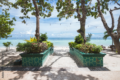 Steps with landscaping leading down to the beach. At Dumaluan Beach in Panglao Island, Bohol, Philippines. photo