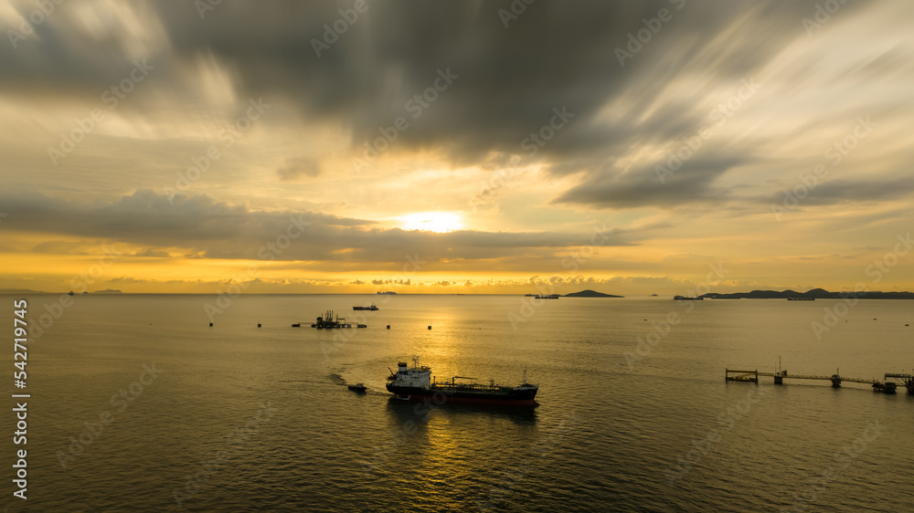 oil tanker ship sailing in sea and the sunset background aerial view photograph from drone,
