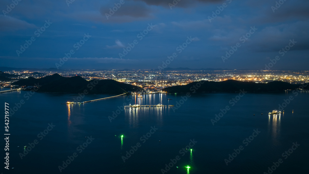 aerial view seascape twilight and lighting from refinery and oil ship in sea blue sky background