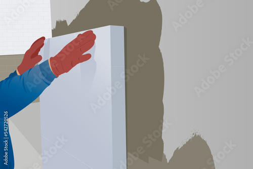 Man worker installs styrofoam heat insulation sheets on the facade wall of the house for thermal protection, home renovation