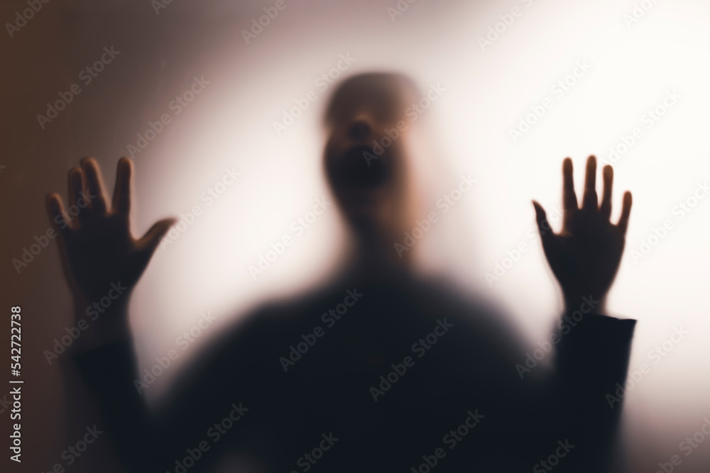Shadowy figure, child behind glass - horror background Shadowy figure, child behind glass - horror background