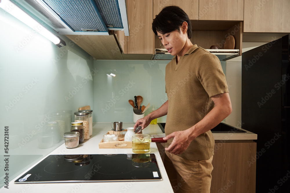 Man Boiling Water on Kitchen Stove Man Boiling Water on Kitchen Stove