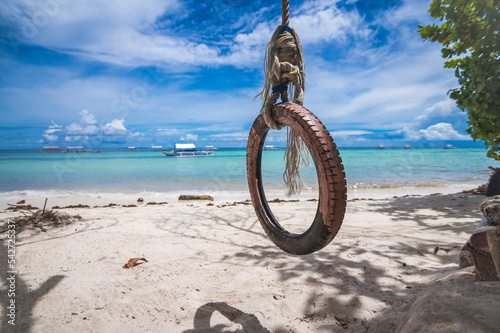 A single tire used as a swing near the beach. At Dumaluan Beach, Panglao, Bohol, Philippines. photo