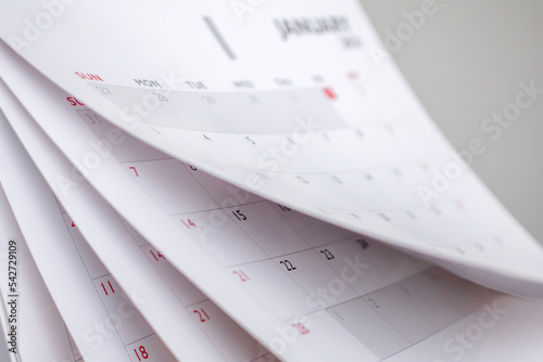 Calendar page flipping sheet close up blur background business schedule planning appointment meeting concept