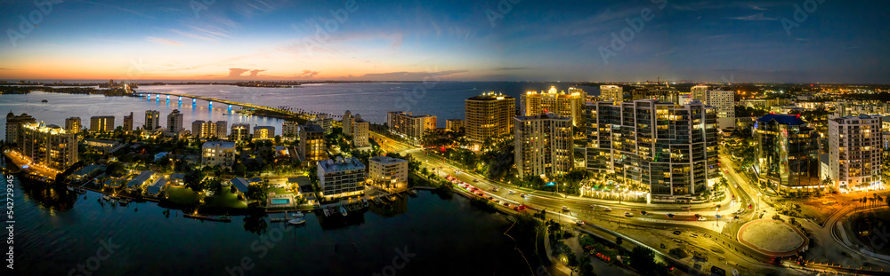 Sarasota aerial blue hour with city and Ringling bridge lit up.