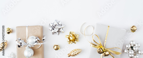 Banner made of Christmas presents and gifts and gold and silver decorations on white background. Merry christmas, New Year holiday concept. Flat lay, top view, copy space.