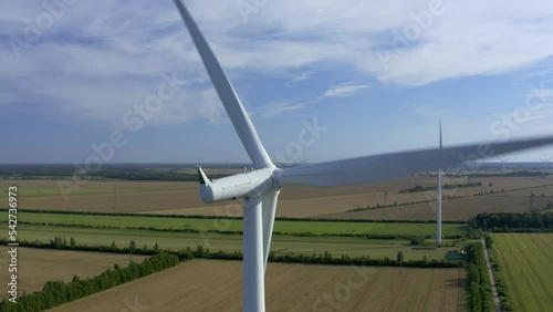 Wind turbines towers on electricity farm spinning and producing green energy