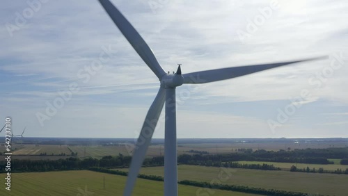 Wind turbines towers on electricity farm spinning and producing green energy