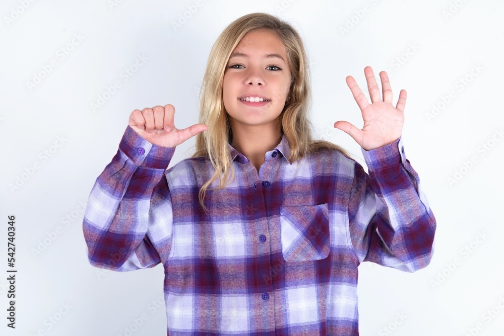 beautiful caucasian teen girl wearing plaid purple shirt over white wall showing and pointing up with fingers number six while smiling confident and happy. beautiful caucasian teen girl wearing plaid purple shirt over white wall showing and pointing up with fingers number six while smiling confident and happy.