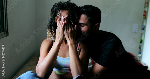 Hispanic couple consoling each other. Partner helping woman emotional support
