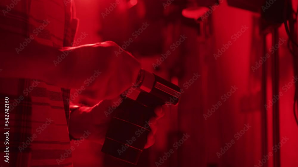 Photographer manually rewinding the film in his camera
