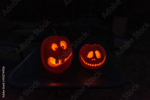 Jack-o-lantern faces with candle light at night