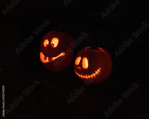 Jack-o-lantern faces with candle light at night
