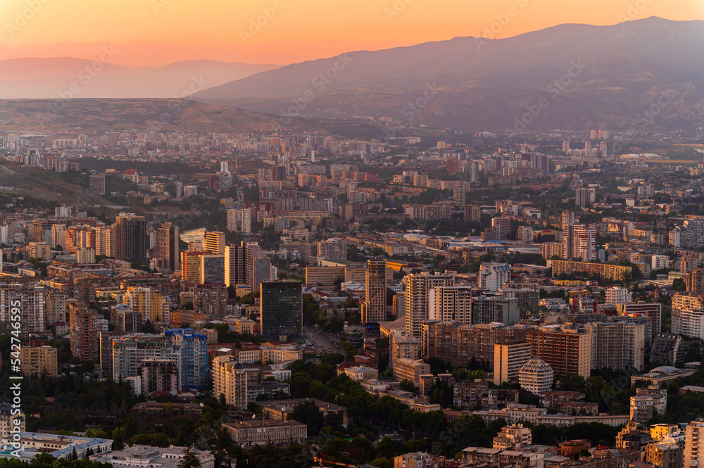 Aerial view of modern skyscrapers and luxurious buildings in downtown Tbilisi, Georgia, with sunset background - Europe landscape