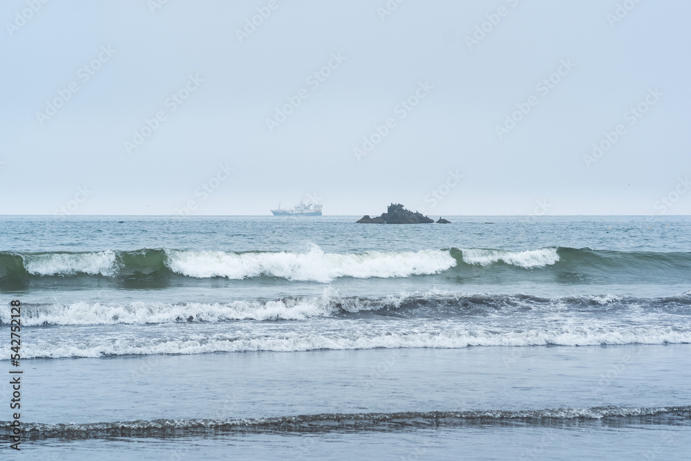 landscape with a sea rock and a sailing ship in the distance landscape with a sea rock and a sailing ship in the distance