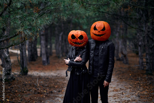 Halloween boy and girl with pumpkins on their heads