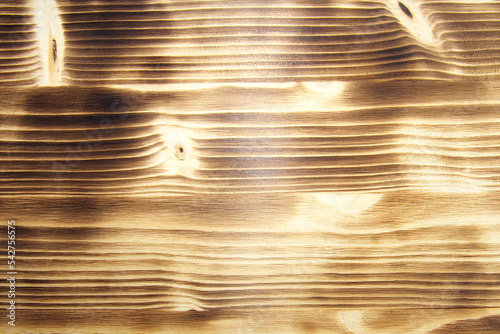 Texture treated surface of burnt pine boards.