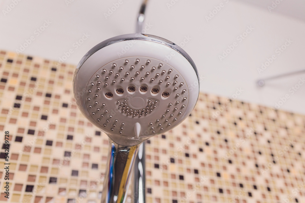 In the bathroom, open shower mixer has attached to the wall bracket ...