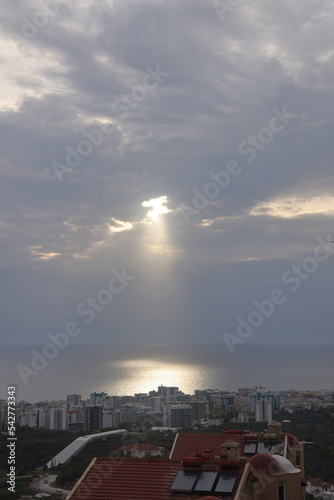 Sunlight on the surface of the sea, Alanya, Turkey, urban development, a ray of sun in the clouds.