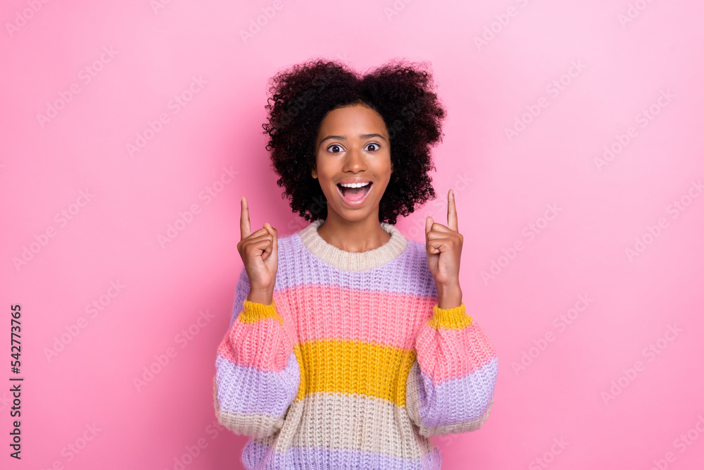 Portrait of excited impressed ecstatic girl wavy hairstyle knit sweatshirt indicating empty space isolated on pink color background Portrait of excited impressed ecstatic girl wavy hairstyle knit sweatshirt indicating empty space isolated on pink color background