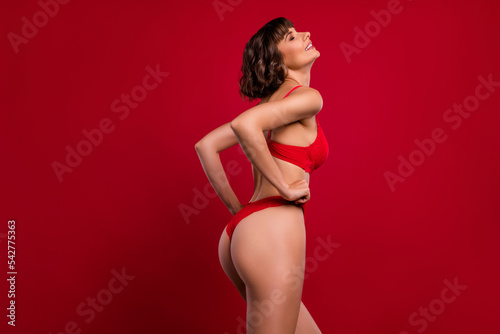Profile side view portrait of attractive alluring dreamy fit nude girl posing teasing isolated over bright red color background