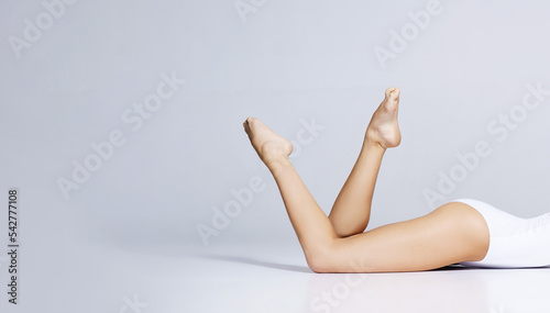 Beautiful legs of sporty girl in underwear. Beautiful and healthy woman posing in studio. Sport, fitness, diet, weight loss and healthcare concept. © Acronym