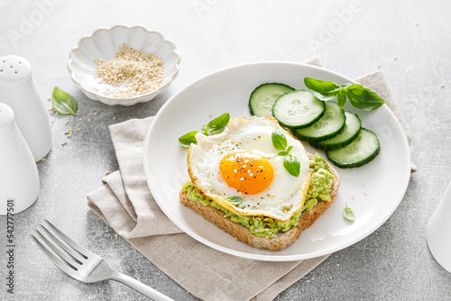 Avocado toast with fried egg for breakfast, healthy food