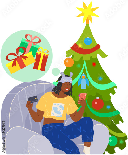 Girl sitting with smartphone and sending online gift. Woman surfing Internet on holiday. Lady celebrates Xmas near Christmas tree. Celebration modern holiday process. Person chooses Christmas presents