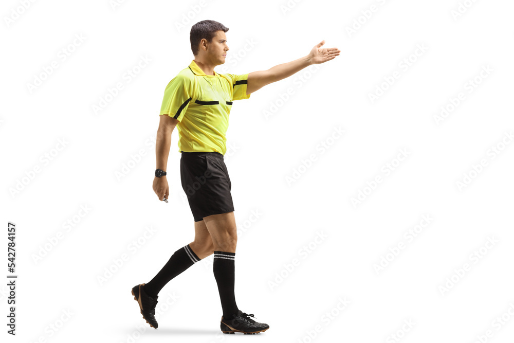Full length profile shot of a football referee pointing with hand and walking