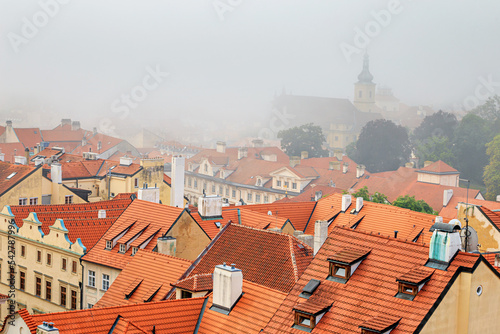 Cityscape on a foggy morning - view of Mala Strana historical neighbourhood of Prague, Czech Republic photo