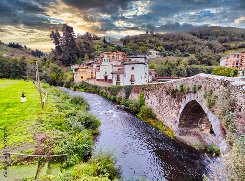 Cangas del Narcea, El Cascarin district where is El Carmen chapel and the roman bridge next to Narcea river, Asturias, Spain photo