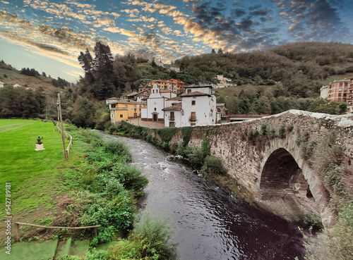 Cangas del Narcea, El Cascarin district where is El Carmen chapel and the roman bridge next to Narcea river, Asturias, Spain photo