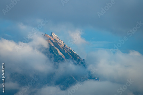 Jagged peaks emerging above the clouds in the pre-alps mountain range of the canton Schwyz, near Sattelegg, Switzerland photo