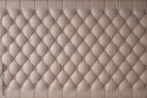 Beige genuine leather upholstery, chesterfield style background. 3D rendering