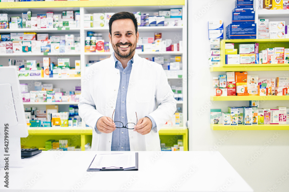 Portrait of young male pharmacist worker in pharmacy store 